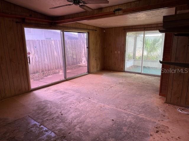 2451 Loma Linda St, Sarasota, FL 34239 - spare room featuring a ceiling fan and wood walls