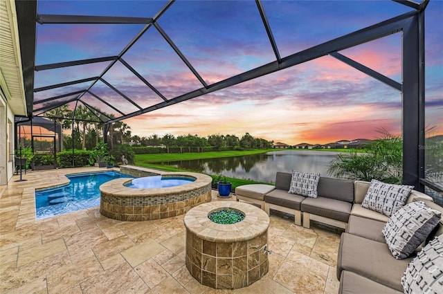4915 Kiva Cir, Bradenton, FL 34211 - pool at dusk featuring a water view, a patio, an outdoor living space with a fire pit, and glass enclosure