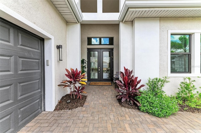 4915 Kiva Cir, Bradenton, FL 34211 - property entrance featuring french doors, stucco siding, and a garage