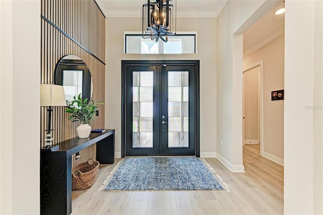 4915 Kiva Cir, Bradenton, FL 34211 - foyer entrance with wood finished floors, a chandelier, french doors, and crown molding