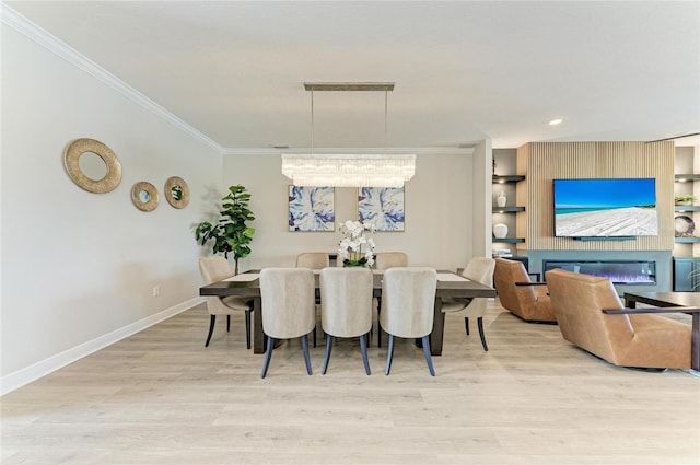 4915 Kiva Cir, Bradenton, FL 34211 - dining room featuring crown molding, wood finished floors, a glass covered fireplace, and built in features