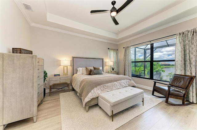 4915 Kiva Cir, Bradenton, FL 34211 - bedroom featuring a tray ceiling, light wood-style floors, ceiling fan, and ornamental molding