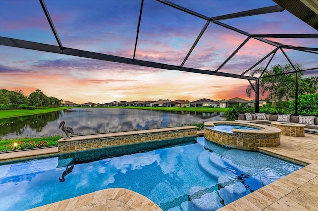 4915 Kiva Cir, Bradenton, FL 34211 - pool at dusk featuring a water view, a patio area, glass enclosure, and a pool with connected hot tub