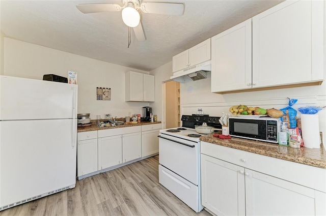 1701 13th St W, Bradenton, FL 34205 - kitchen featuring white appliances, under cabinet range hood, light wood finished floors, white cabinets, and ceiling fan