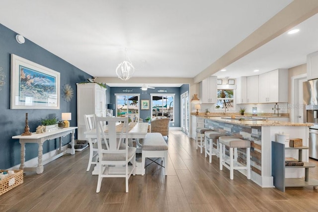 3850 Catalina Dr, Bradenton, FL 34210 - dining area with wood finished floors, a chandelier, and recessed lighting