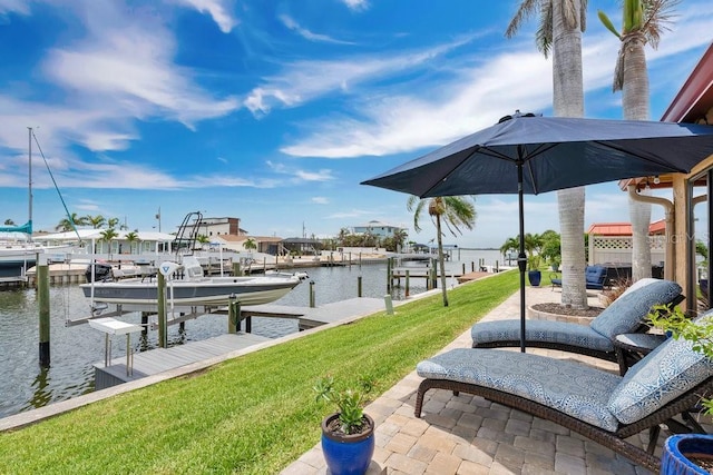 3850 Catalina Dr, Bradenton, FL 34210 - dock area featuring boat lift, a water view, and a yard