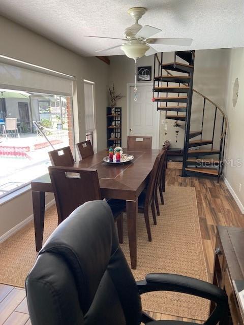 3683 Brown, Arcadia, FL 34266 - dining space featuring stairway, a textured ceiling, a ceiling fan, and wood finished floors