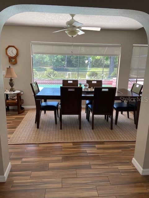 3683 Brown, Arcadia, FL 34266 - dining space with arched walkways, a ceiling fan, and wood finished floors