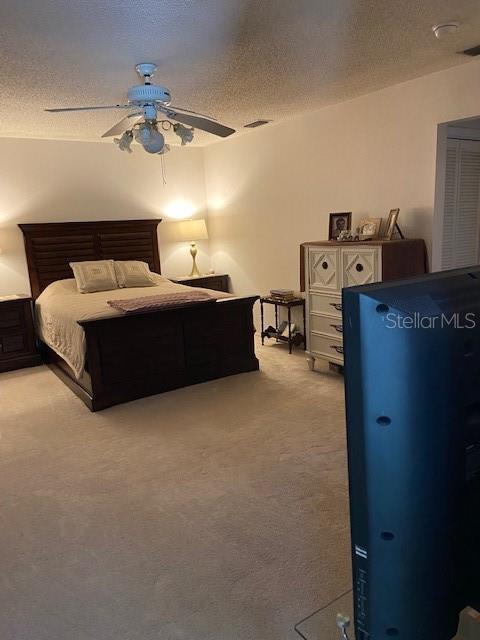 3683 Brown, Arcadia, FL 34266 - bedroom featuring light carpet, a textured ceiling, and a ceiling fan