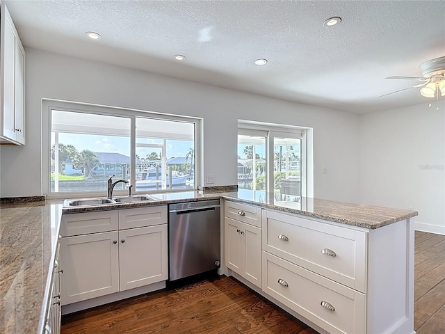 6341 Cocoa Ln, Apollo Beach, FL 33572 - kitchen with dishwasher, a peninsula, ceiling fan, dark wood finished floors, and white cabinetry