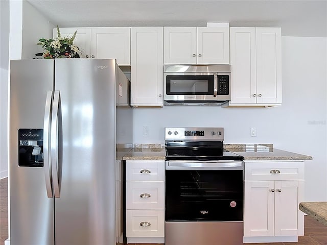 6341 Cocoa Ln, Apollo Beach, FL 33572 - kitchen featuring appliances with stainless steel finishes, white cabinetry, and light stone counters