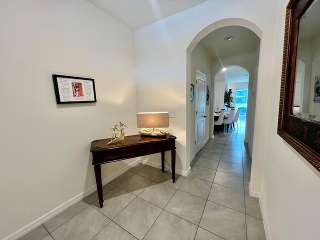 8995 Milestone Dr, Sarasota, FL 34238 - corridor with arched walkways and light tile patterned floors