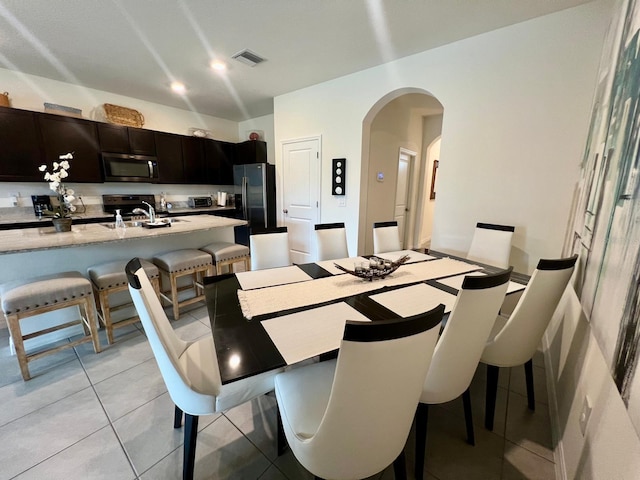 8995 Milestone Dr, Sarasota, FL 34238 - dining area featuring arched walkways and light tile patterned flooring