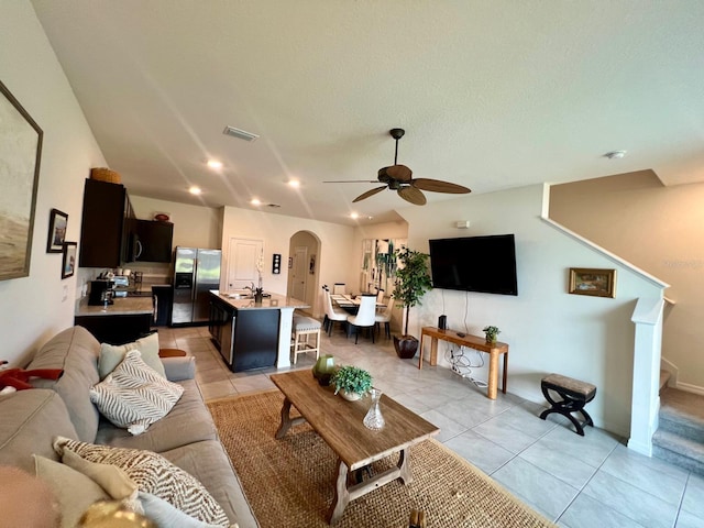 8995 Milestone Dr, Sarasota, FL 34238 - living area with ceiling fan, light tile patterned flooring, arched walkways, recessed lighting, and stairway