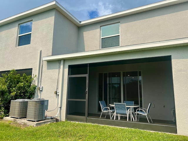 8995 Milestone Dr, Sarasota, FL 34238 - rear view of house with stucco siding and a sunroom