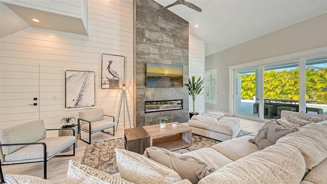 8006 20th Pl W, Bradenton, FL 34209 - living area featuring high vaulted ceiling, a tile fireplace, recessed lighting, wood walls, and wood finished floors
