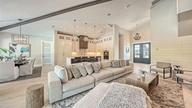 8006 20th Pl W, Bradenton, FL 34209 - living room featuring a chandelier, light wood finished floors, and high vaulted ceiling