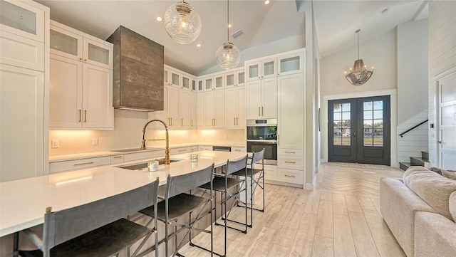 8006 20th Pl W, Bradenton, FL 34209 - kitchen with high vaulted ceiling, french doors, light countertops, double oven, and a kitchen bar
