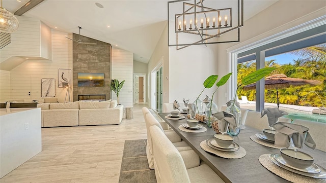 8006 20th Pl W, Bradenton, FL 34209 - dining area with high vaulted ceiling, healthy amount of natural light, wood finished floors, recessed lighting, and a tiled fireplace