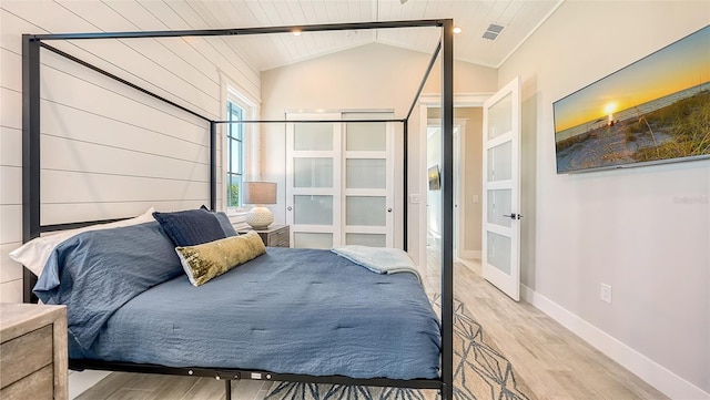8006 20th Pl W, Bradenton, FL 34209 - bedroom with light wood-style floors, lofted ceiling, and wood ceiling