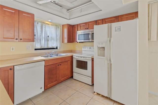 4805 Cypress Lake Ct, Sarasota, FL 34243 - kitchen featuring white appliances, light tile patterned flooring, light countertops, and brown cabinets