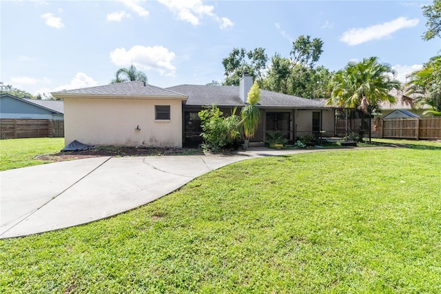 4805 Cypress Lake Ct, Sarasota, FL 34243 - rear view of property with a chimney, stucco siding, and a sunroom