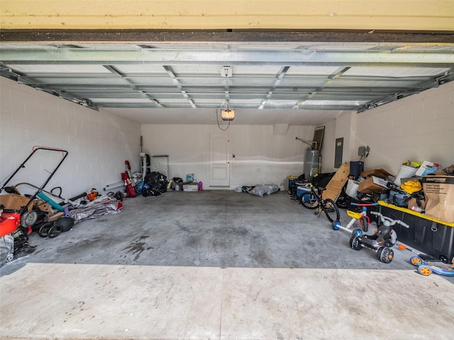 938 Mansfield Rd, Tavares, FL 32778 - garage featuring a garage door opener, electric panel, water heater, and concrete block wall