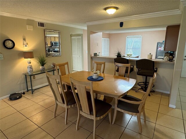 3810 75th St W Unit 137, Bradenton, FL 34209 - dining area featuring crown molding, a textured ceiling, and light tile patterned floors
