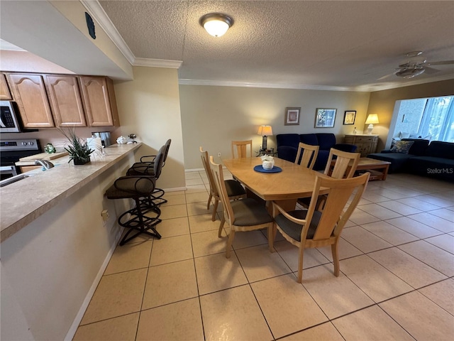 3810 75th St W Unit 137, Bradenton, FL 34209 - dining room featuring light tile patterned floors, ornamental molding, and a textured ceiling