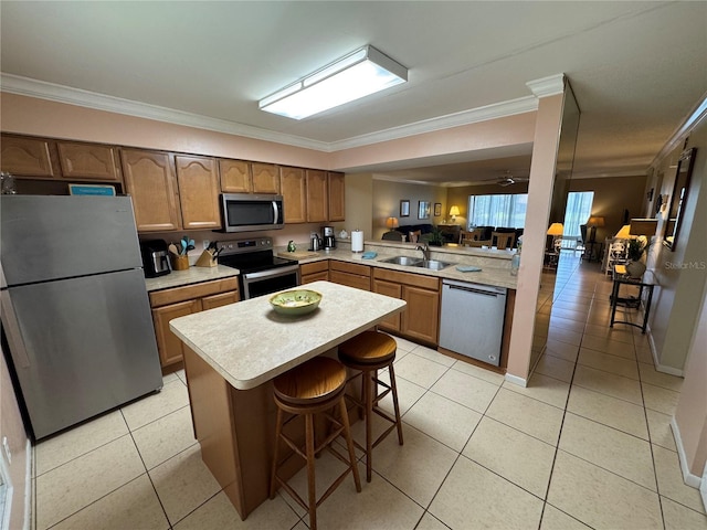 3810 75th St W Unit 137, Bradenton, FL 34209 - kitchen featuring stainless steel appliances, crown molding, light countertops, a peninsula, and open floor plan