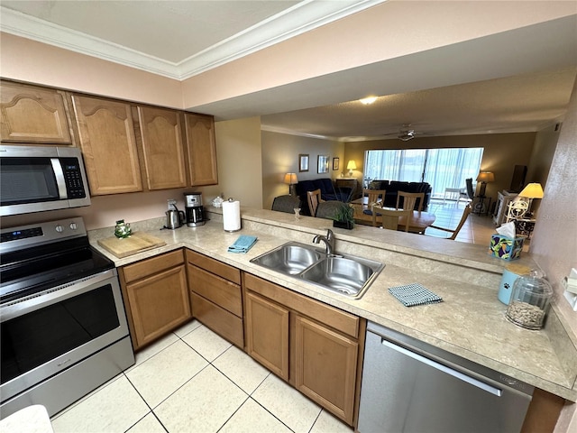 3810 75th St W Unit 137, Bradenton, FL 34209 - kitchen with appliances with stainless steel finishes, crown molding, light countertops, a peninsula, and open floor plan