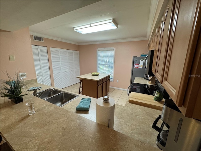 3810 75th St W Unit 137, Bradenton, FL 34209 - kitchen with ornamental molding, freestanding refrigerator, a kitchen island, a kitchen breakfast bar, and black electric range oven