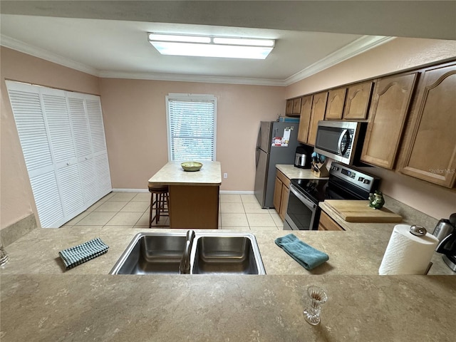 3810 75th St W Unit 137, Bradenton, FL 34209 - kitchen with stainless steel appliances, crown molding, light tile patterned flooring, light countertops, and a center island