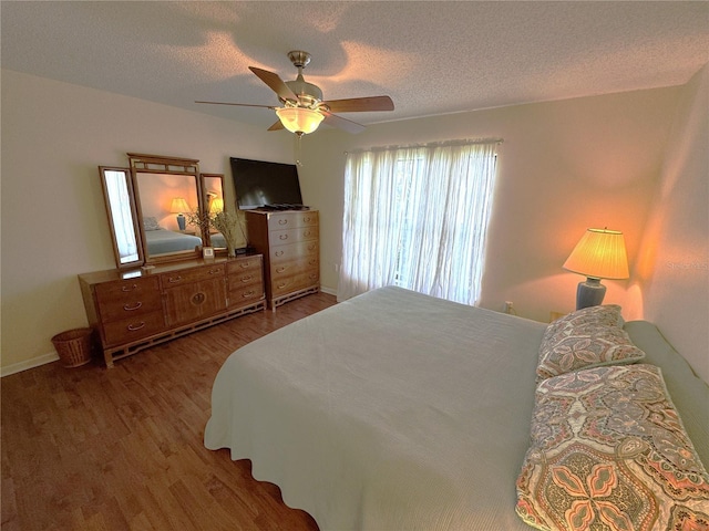3810 75th St W Unit 137, Bradenton, FL 34209 - bedroom featuring wood finished floors, a textured ceiling, and a ceiling fan