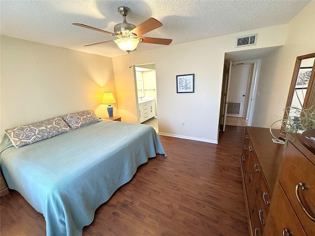 3810 75th St W Unit 137, Bradenton, FL 34209 - bedroom with dark wood-style flooring, a textured ceiling, ceiling fan, and connected bathroom