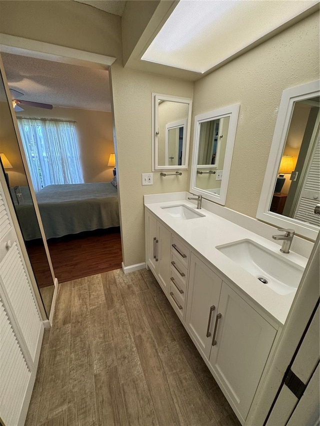 3810 75th St W Unit 137, Bradenton, FL 34209 - bathroom featuring ensuite bath, wood finished floors, double vanity, and ceiling fan