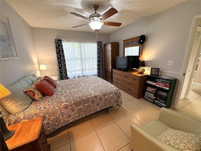 3810 75th St W Unit 137, Bradenton, FL 34209 - bedroom featuring light tile patterned floors, a textured ceiling, and ceiling fan