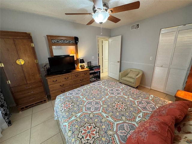 3810 75th St W Unit 137, Bradenton, FL 34209 - bedroom featuring light tile patterned floors, a ceiling fan, a closet, and a textured ceiling