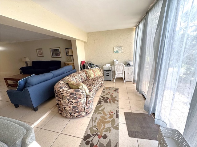 3810 75th St W Unit 137, Bradenton, FL 34209 - living area with light tile patterned floors, healthy amount of natural light, a textured wall, and ornamental molding