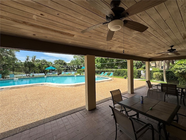 3810 75th St W Unit 137, Bradenton, FL 34209 - view of patio / terrace with outdoor dining area, a community pool, and ceiling fan