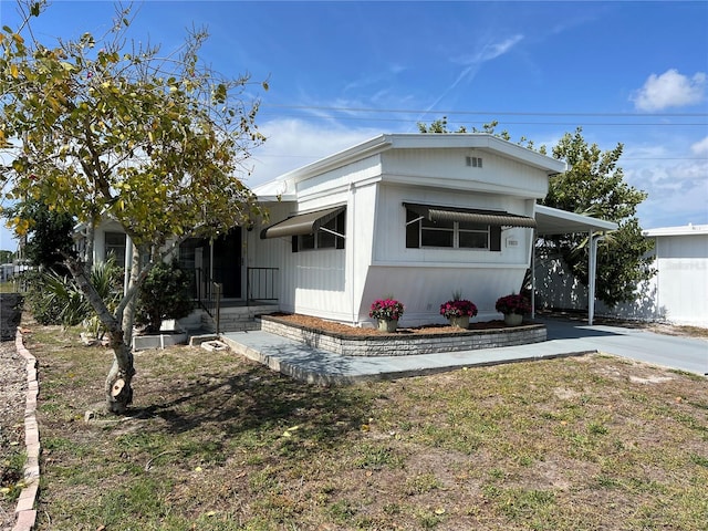 1871 Palm Springs St, Sarasota, FL 34234 - manufactured / mobile home with driveway and an attached carport