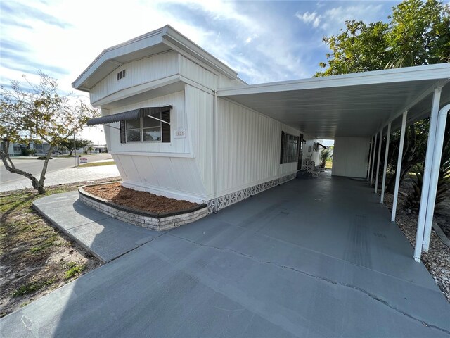 1871 Palm Springs St, Sarasota, FL 34234 - view of side of property featuring concrete driveway and an attached carport