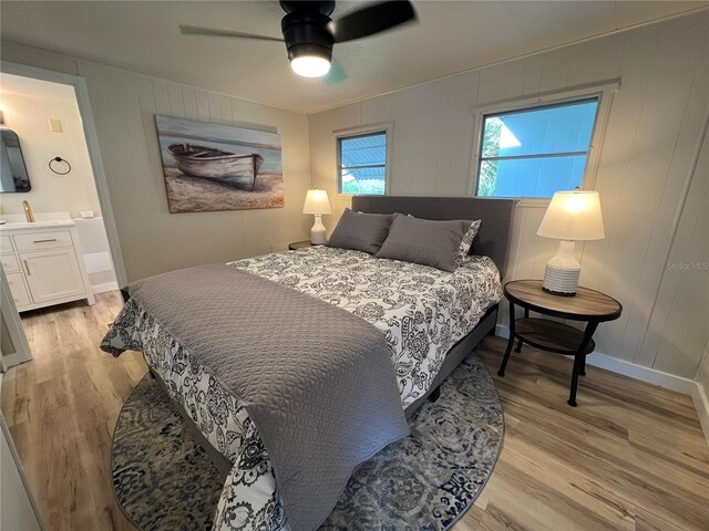 1871 Palm Springs St, Sarasota, FL 34234 - bedroom with light wood-type flooring, ceiling fan, a decorative wall, and ensuite bathroom