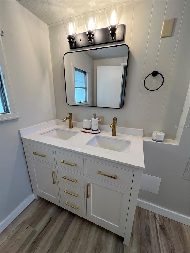 1871 Palm Springs St, Sarasota, FL 34234 - bathroom with double vanity, wood finished floors, and a textured ceiling