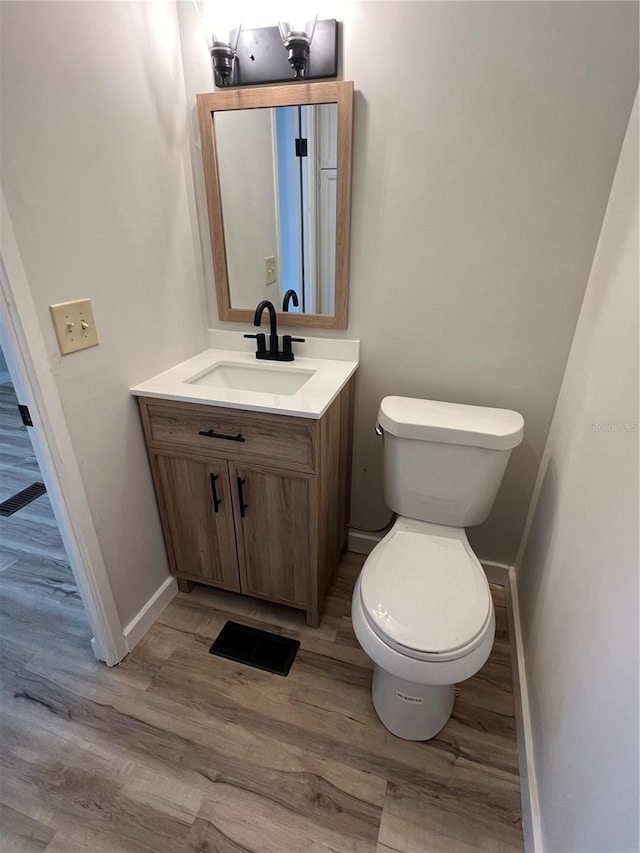 1871 Palm Springs St, Sarasota, FL 34234 - half bathroom with vanity and wood finished floors
