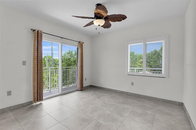 830 Egret Ln, Key Largo, FL 33037 - empty room with healthy amount of natural light, a ceiling fan, and light tile patterned floors