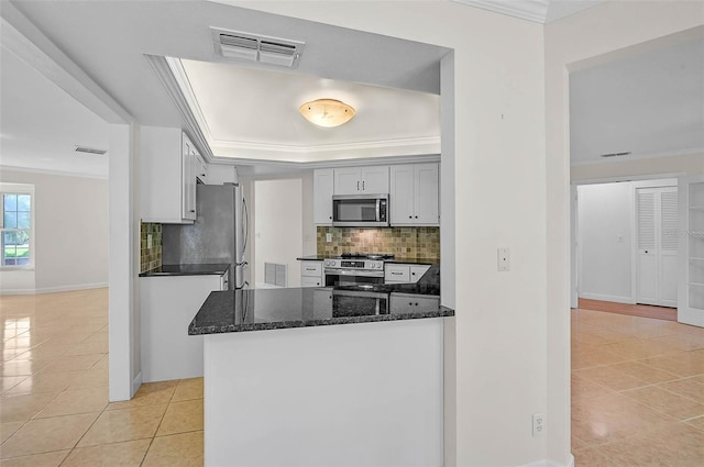 1674 Cottonwood Trl, Sarasota, FL 34232 - kitchen with stainless steel appliances, light tile patterned floors, crown molding, backsplash, and dark stone countertops