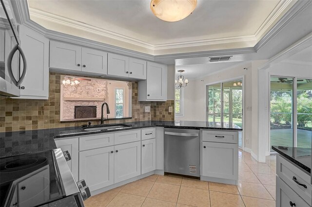 1674 Cottonwood Trl, Sarasota, FL 34232 - kitchen featuring stainless steel appliances, ornamental molding, light tile patterned flooring, a chandelier, and a peninsula
