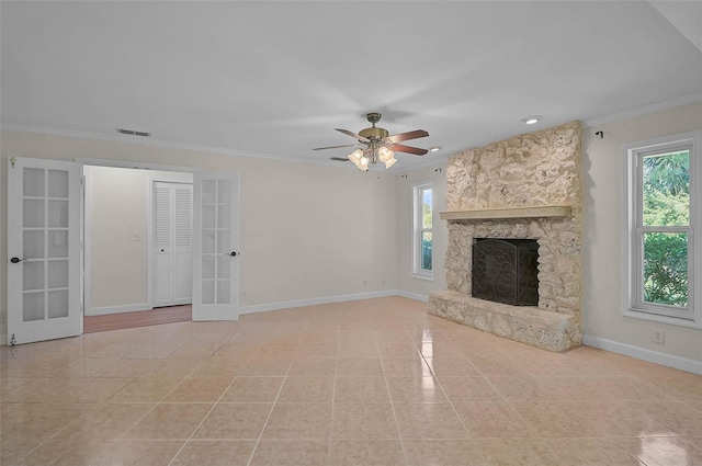 1674 Cottonwood Trl, Sarasota, FL 34232 - unfurnished living room with healthy amount of natural light, french doors, ornamental molding, light tile patterned floors, and a fireplace