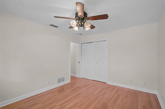 1674 Cottonwood Trl, Sarasota, FL 34232 - unfurnished bedroom with light wood-type flooring, a closet, and ceiling fan